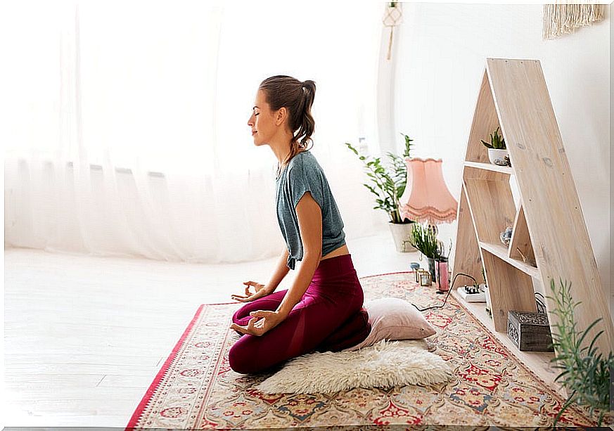 Woman practicing meditation at home.