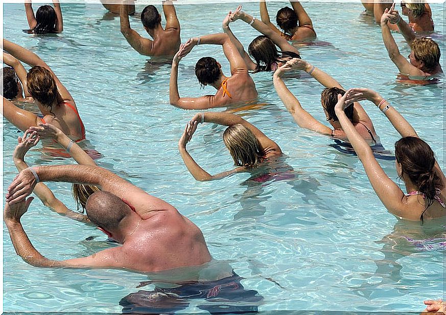 Group of people doing aerobics in a swimming pool