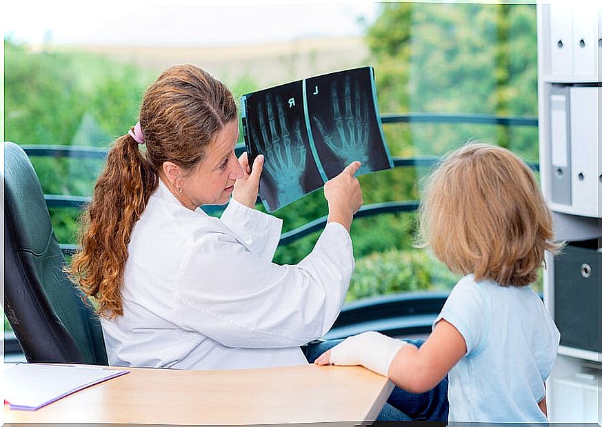 Pediatrician with girl and x-ray