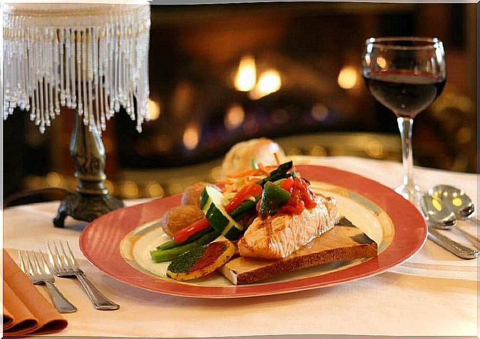 Plate with food and glass of wine.