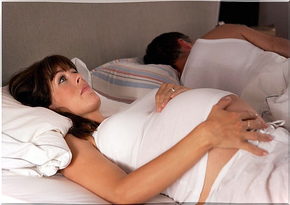 Woman lying in bed with eyes wide open. 