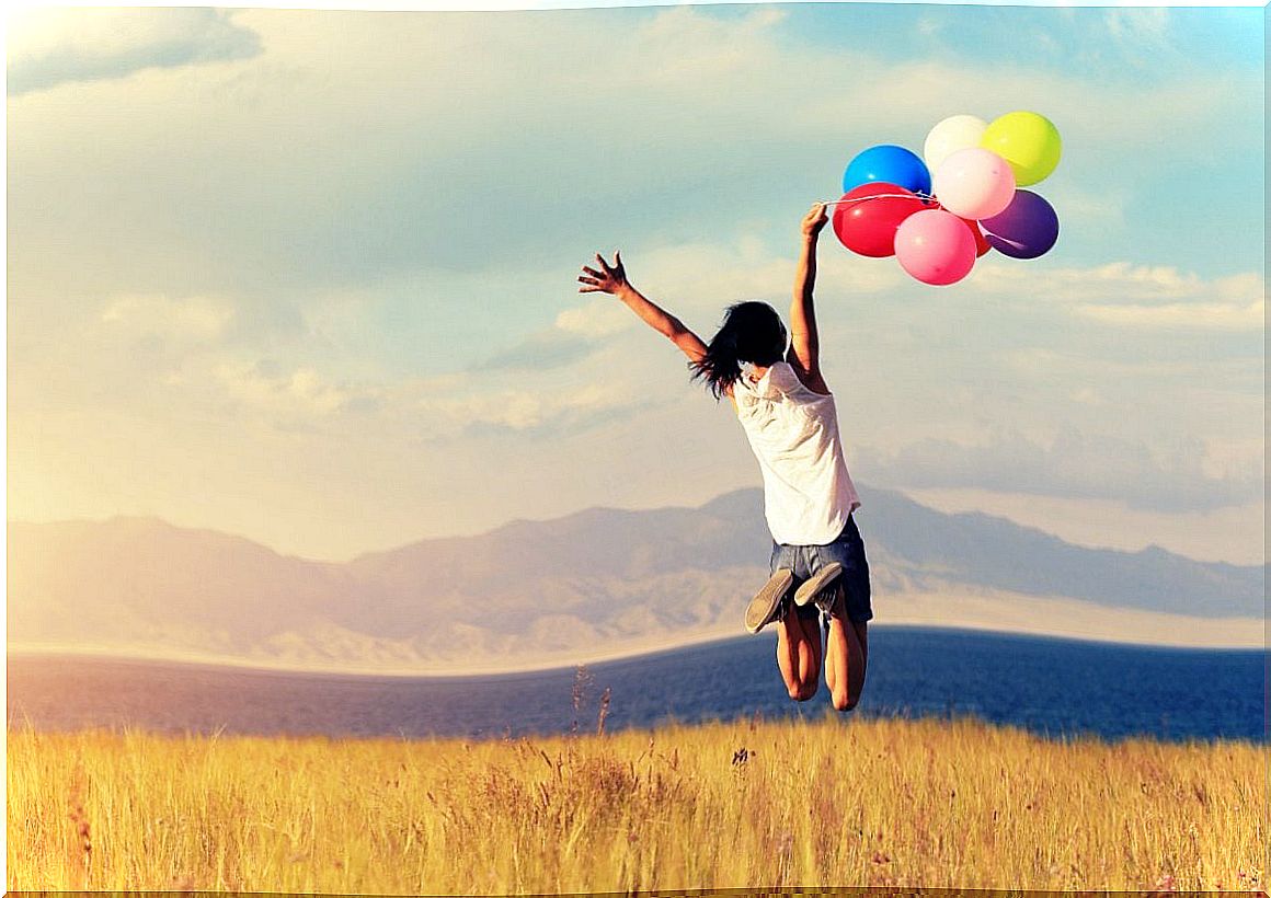 Woman jumping with balloons