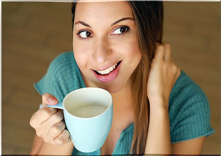 Woman drinking milk from a cup.