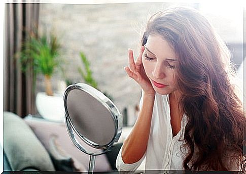 woman looking at herself in the mirror